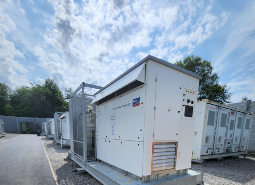 Battery containers and inverter against blue sky